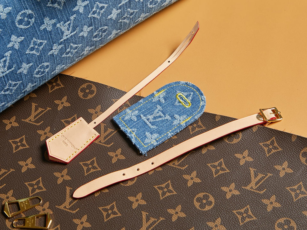 Blue Louis Vuitton monogram accessory set with wristlet and straps on bag.