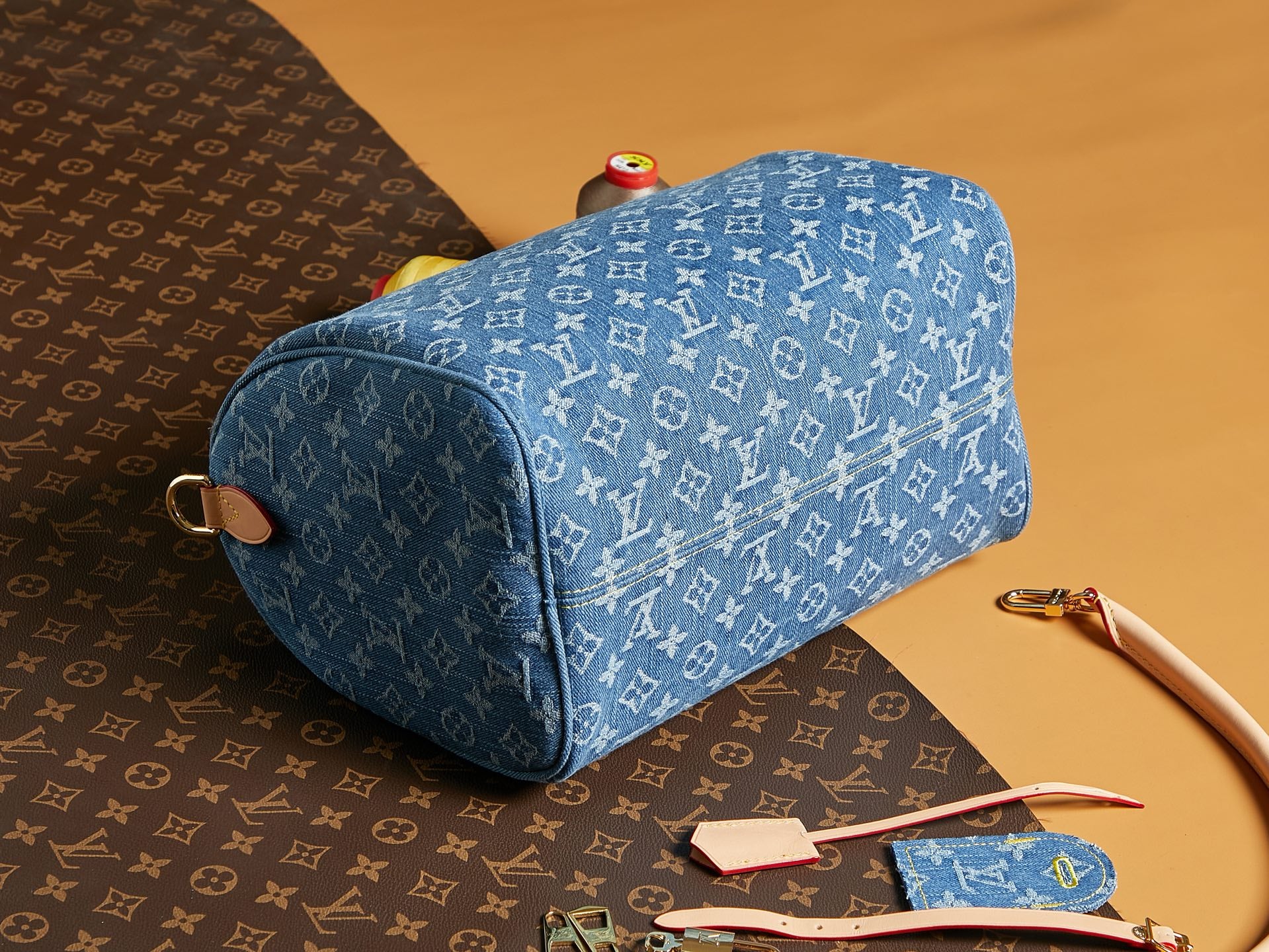 Blue Louis Vuitton monogram barrel bag with curved handle and top zipper.