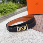 Black leather belt with gold-tone buckle, shown flat with tan underside