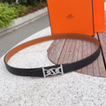 Black leather Hermes belt with silver-tone buckle and prong closure