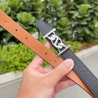 Two-tone Hermes belt: black exterior and tan lining with punched holes