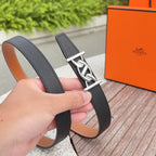 Black leather Hermes belt with silver buckle on textured strap