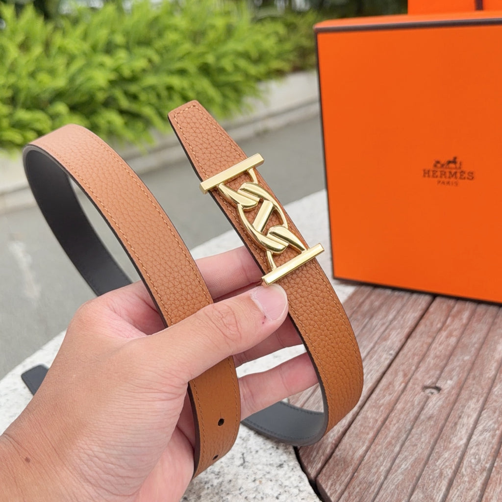 Hermes belt in tan leather with gold buckle, shown from side with inner dark lining