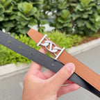 Hermes belt showing tan leather and black strap with rivet holes
