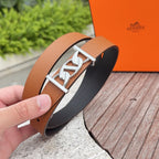 Hermes belt close-up with silver H-style buckle on tan leather
