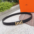 Leather belt with black strap and gold-toned buckle clasp