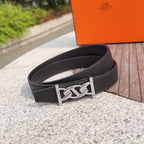 Hermes black leather belt with silver-tone buckle and H emblem, angled view
