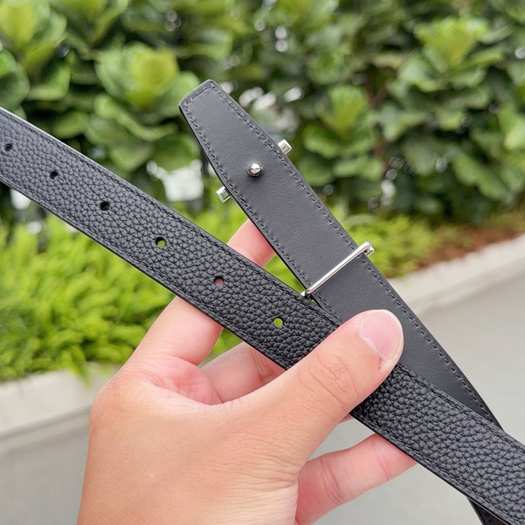 Hermes black leather belt with adjustable holes and silver pin buckle plate, close-up