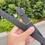 Hermes black leather belt with adjustable holes and silver pin buckle plate, close-up