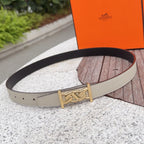 Beige leather belt with gold-tone buckle and dark strap lining