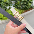 Beige leather belt with gold-tone buckle and dark underside strap