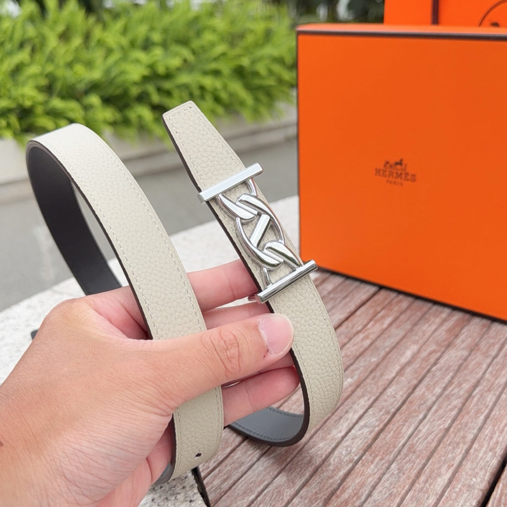 Hermes leather belt close-up in light beige with silver buckle and stitched edge