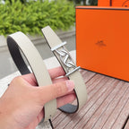Hermes leather belt close-up in light beige with silver buckle and stitched edge