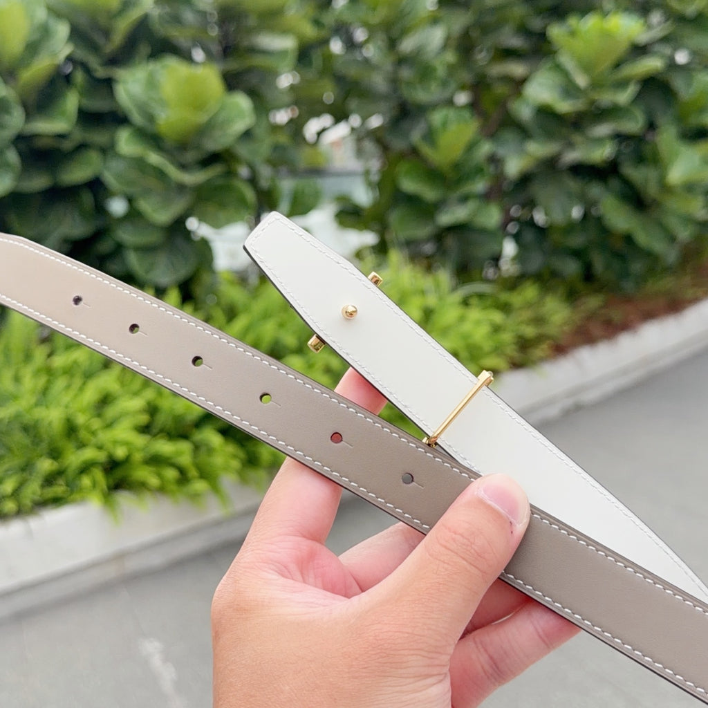 Off-white leather belt with gold buckle and row of punched holes