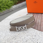 Hermes leather belt, taupe, silver-tone buckle centered with visible stitched edges.