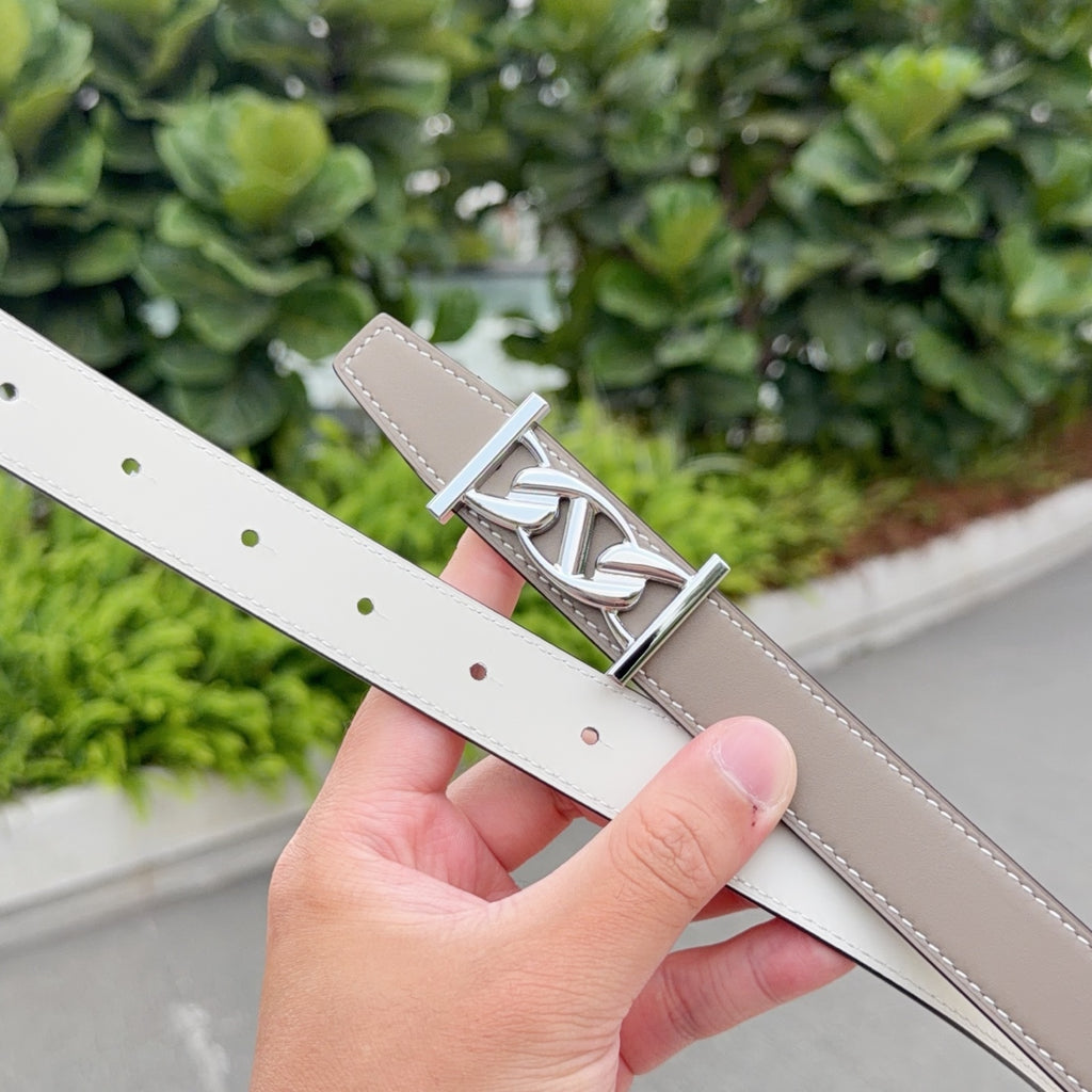 Reversible Hermes leather belt with taupe and white sides, silver-tone H buckle.