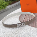 Hermes leather belt in taupe with silver-tone buckle and punched holes.