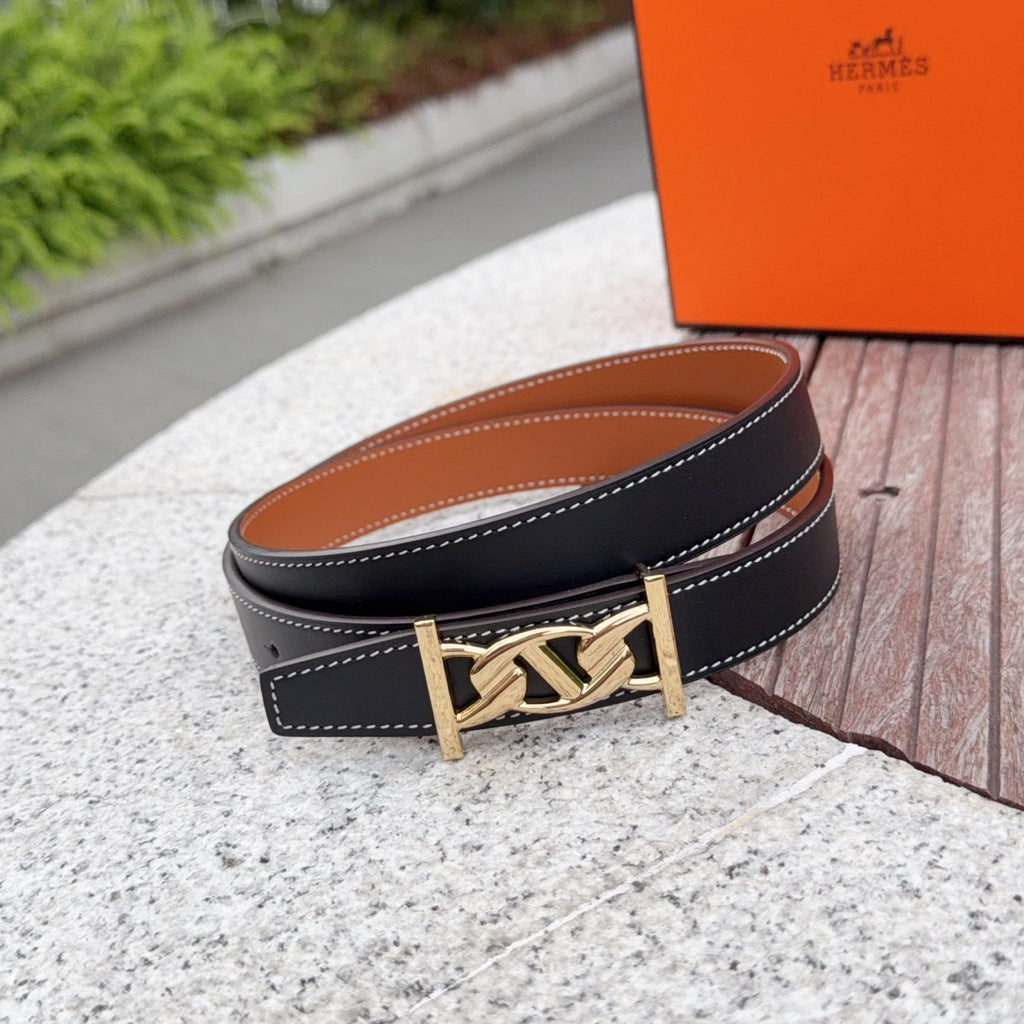 Leather belt with gold-tone buckle, dark blue strap with tan underside and white stitching