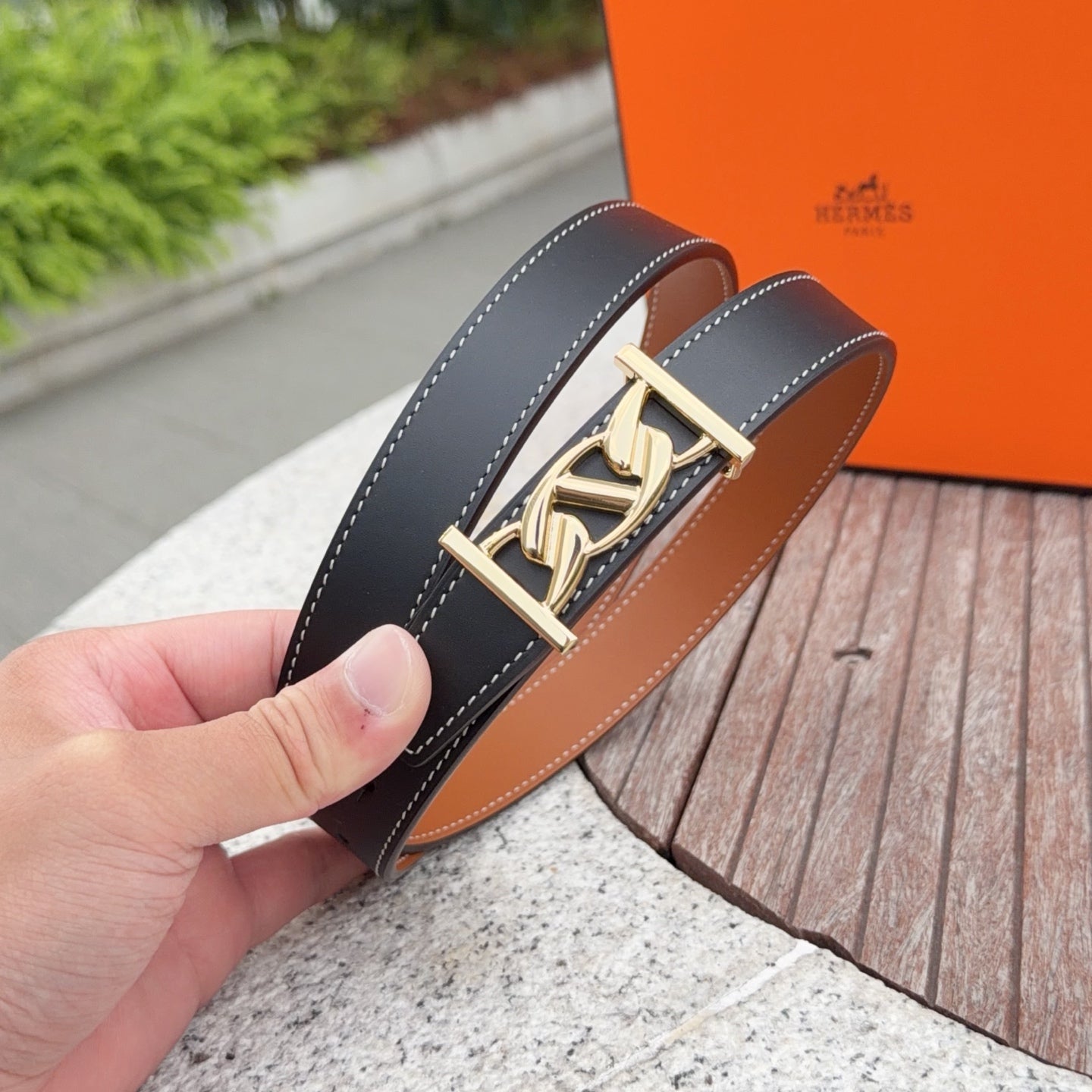 Leather belt with gold-tone buckle, dark blue strap and tan inner lining