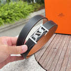 Dark leather belt with silver H-style buckle, hand-held close-up