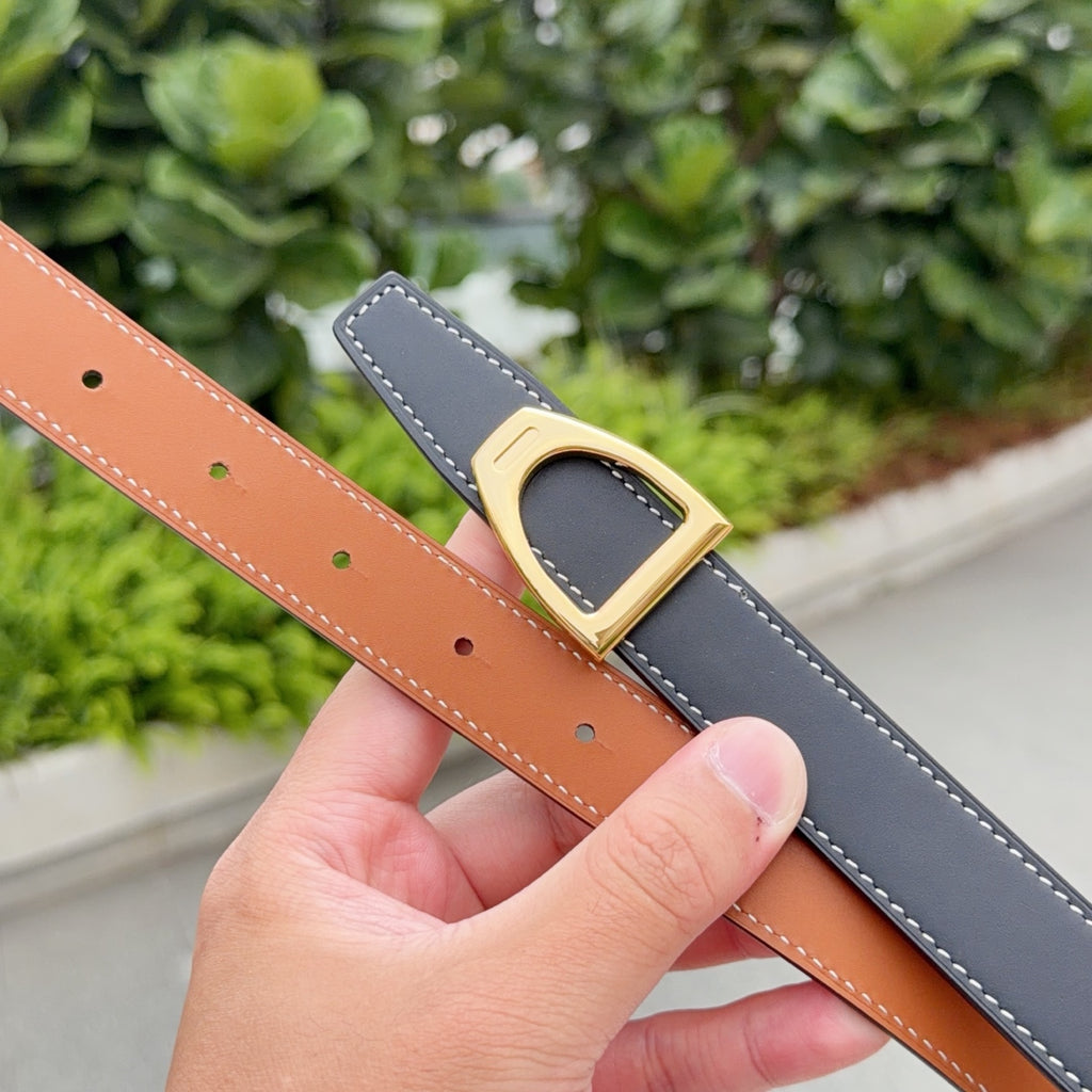 Leather belt with tan strap, gold buckle, and perforated adjustment holes