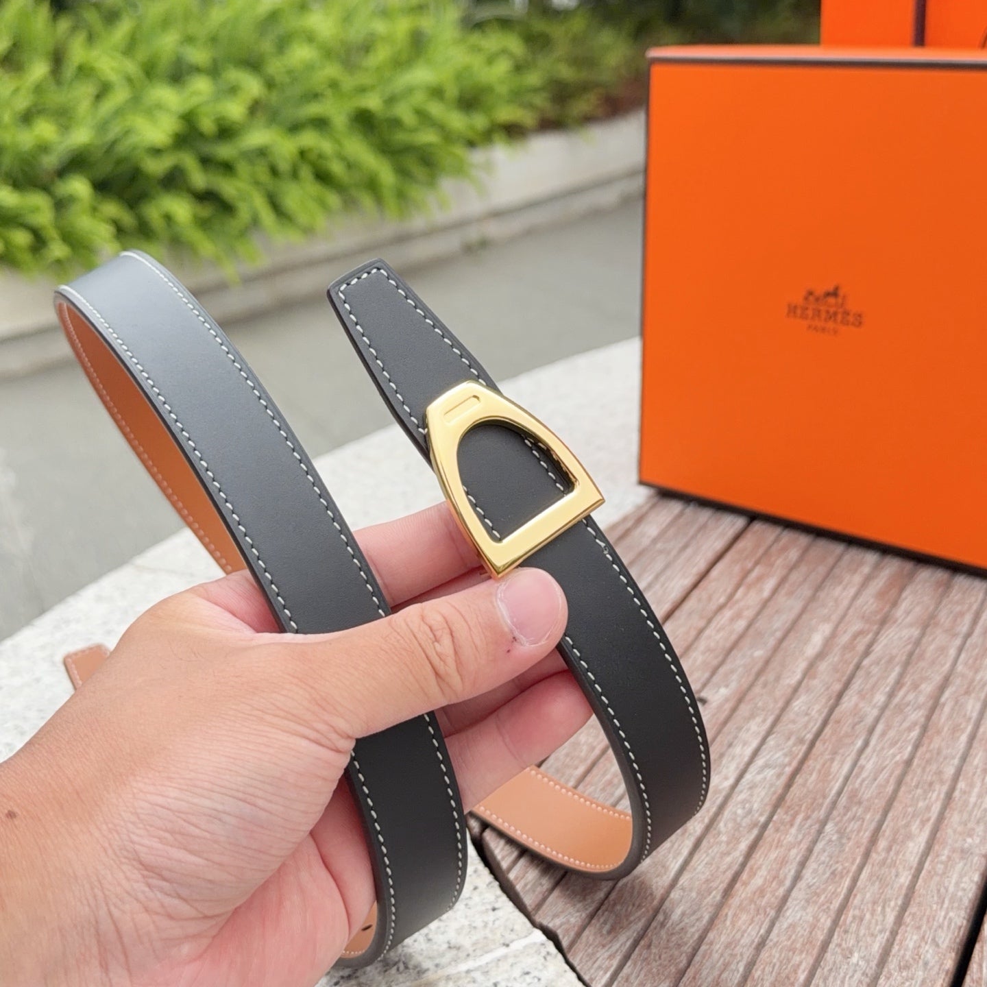 Leather belt with gray strap, gold buckle, and tan underside with contrast stitching