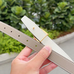 Light leather belt strap with gold-tone keeper and punched adjustment holes