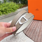 Hermes belt detail: silver-tone buckle with light taupe leather strap