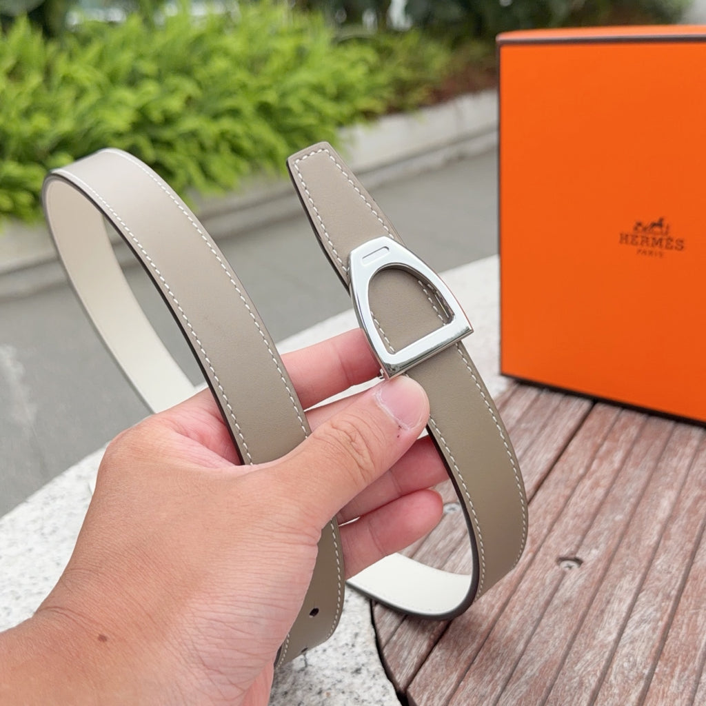 Hermes belt with light taupe strap and silver buckle, shown from the side edge