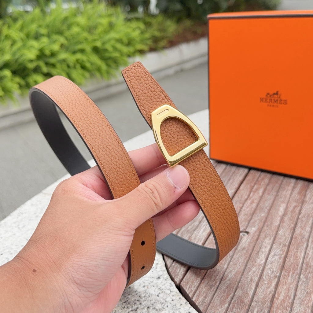 Tan leather belt with gold buckle, black lining, and row of punched holes.
