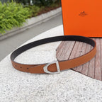 Leather belt with orange-brown strap, silver buckle, and punched adjustment holes