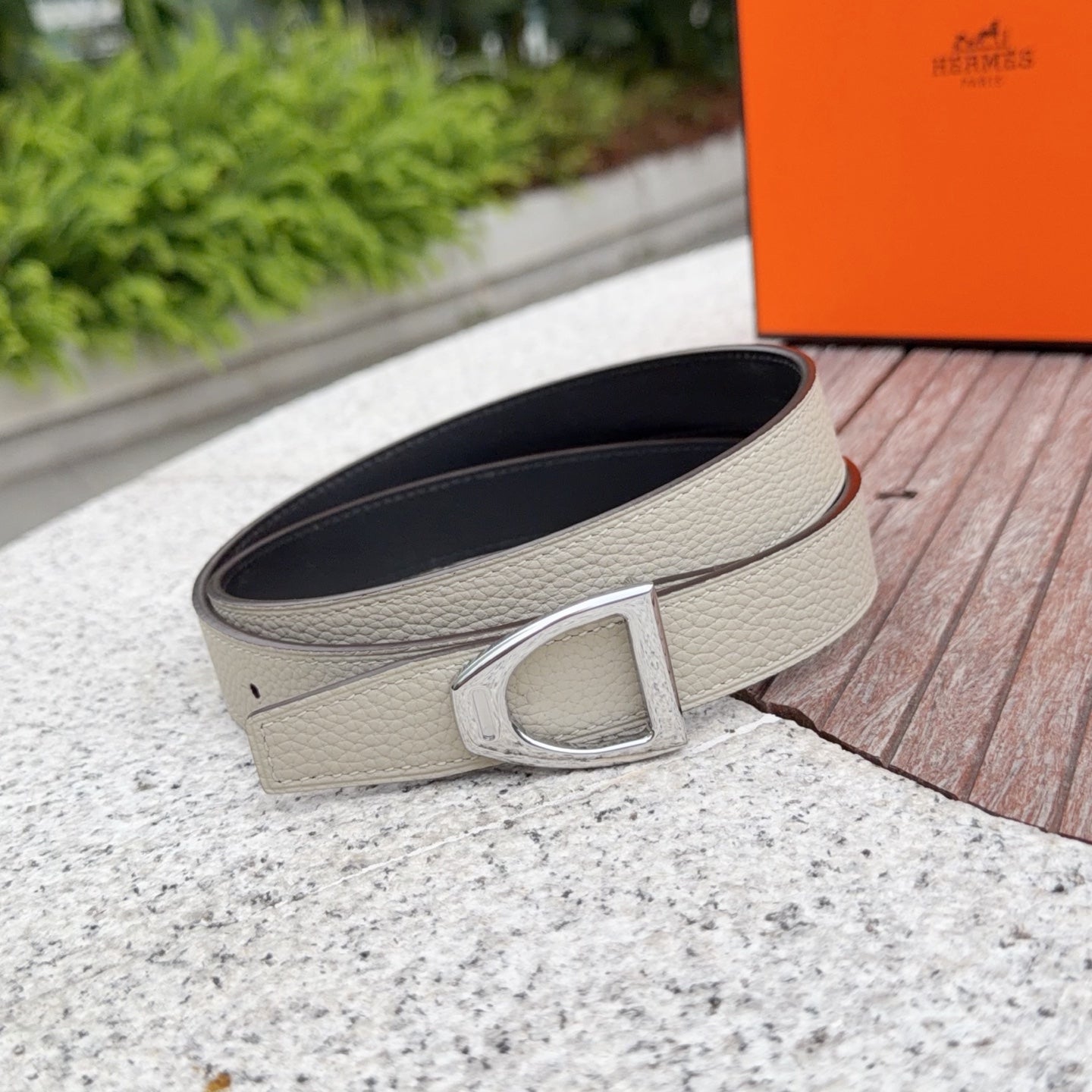 Light beige leather belt with silver buckle and dark interior lining