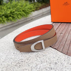 Tan leather belt with silver square buckle and orange lining