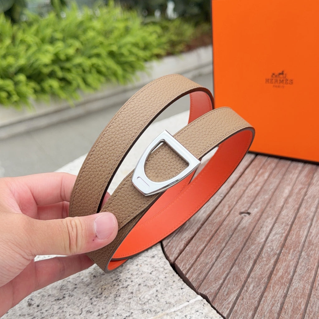 Brown leather belt with silver buckle and orange underside