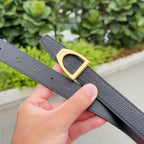 Black textured leather belt with gold-tone buckle and punched eyelets