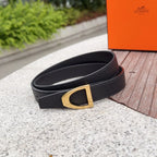 Black leather belt with gold-tone buckle and textured grain