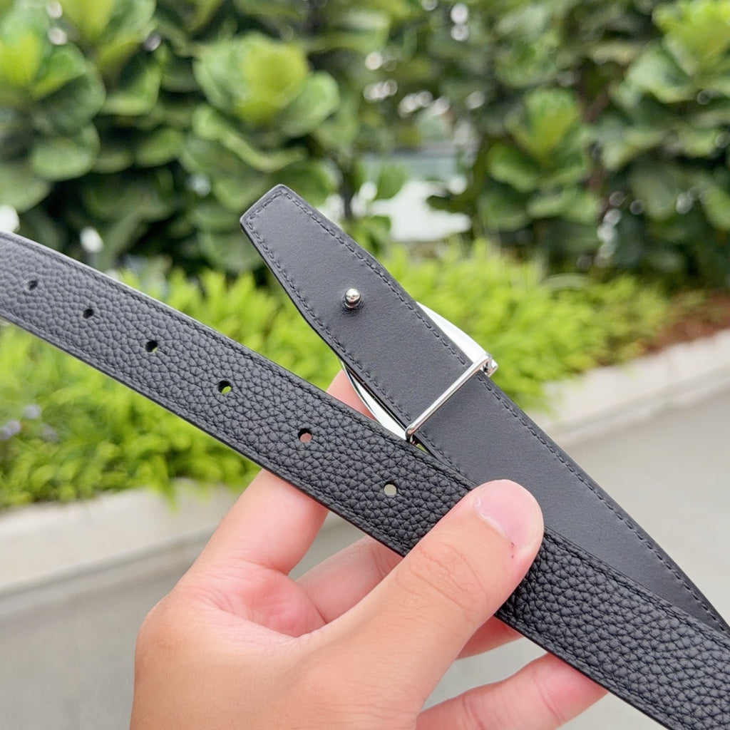 Gray leather belt with silver buckle tip and visible adjustment holes