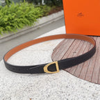 Leather belt with black strap and gold square buckle, tan underside visible