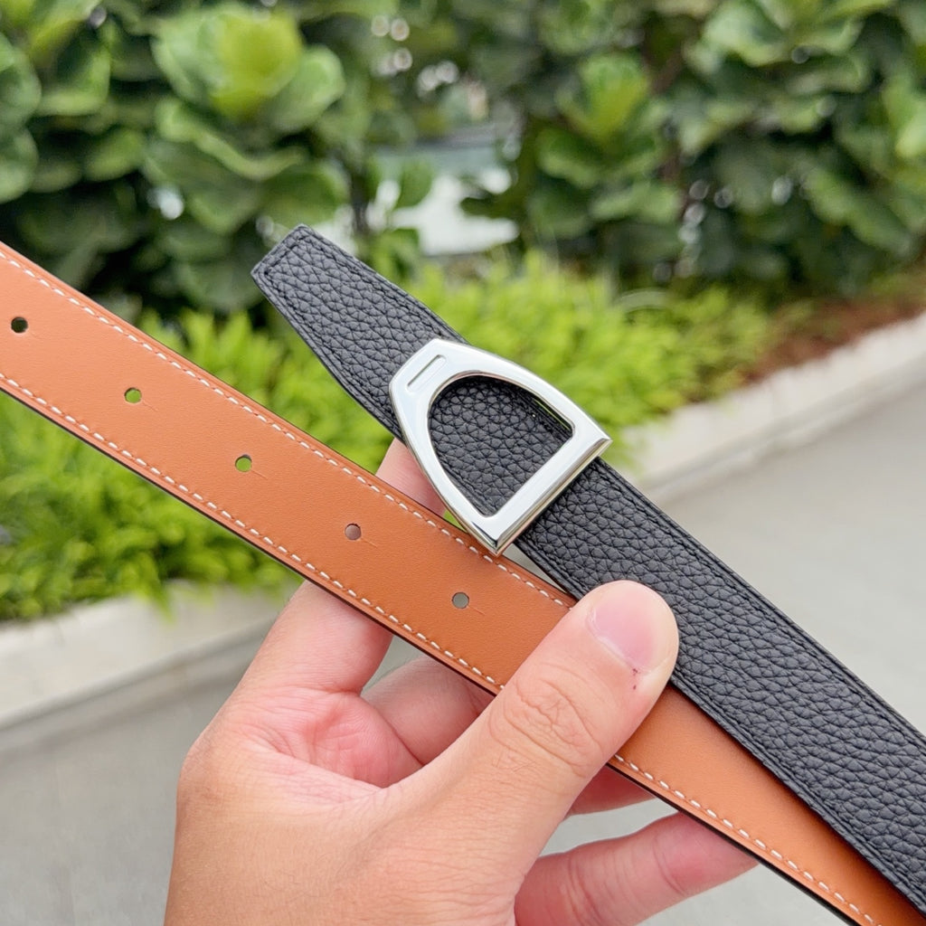Black leather belt with silver-tone buckle; tan lining and punched holes