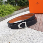 Black leather belt with silver-tone buckle; tan underside visible