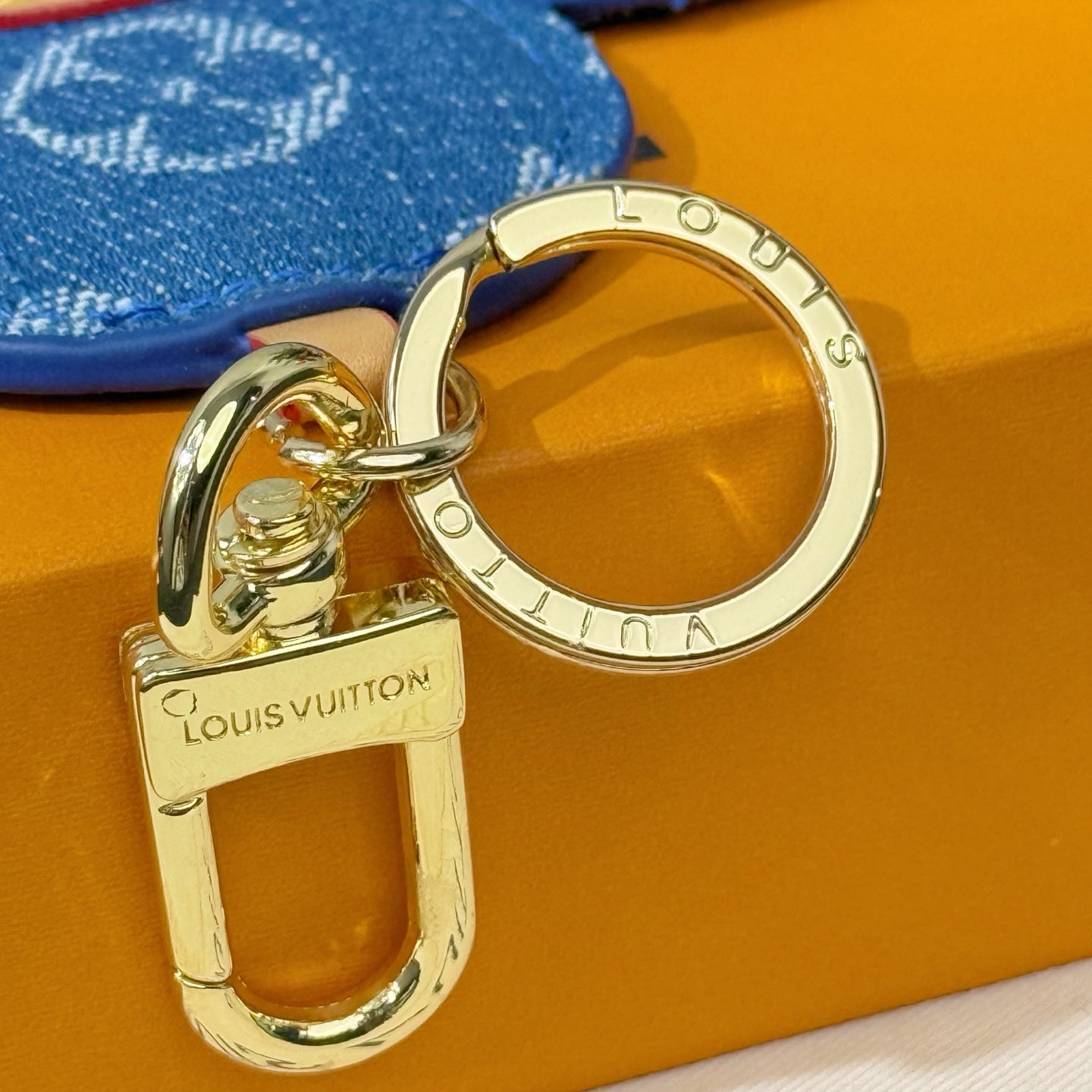 Louis Vuitton metal keyring and clip attached to blue monogram flower charm