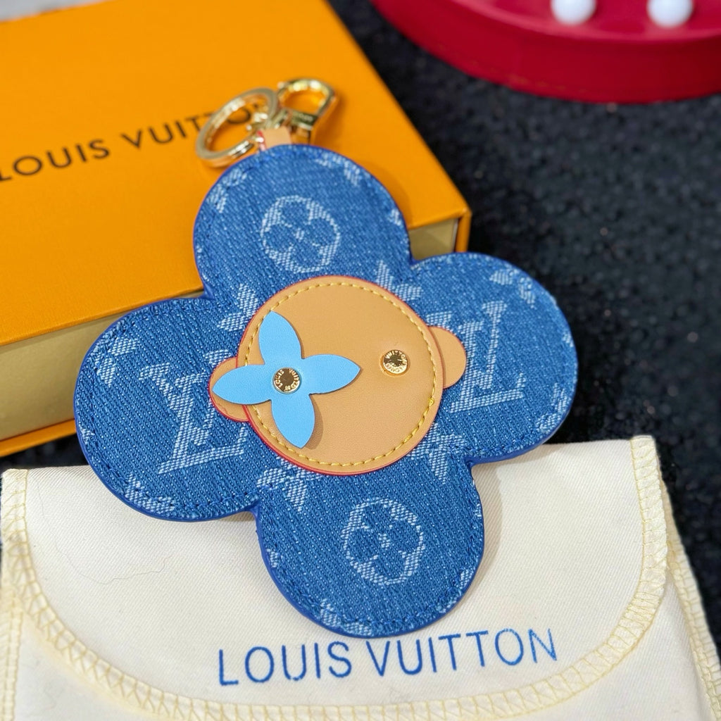 Louis Vuitton blue flower keychain charm with beige emblem center and metal hardware