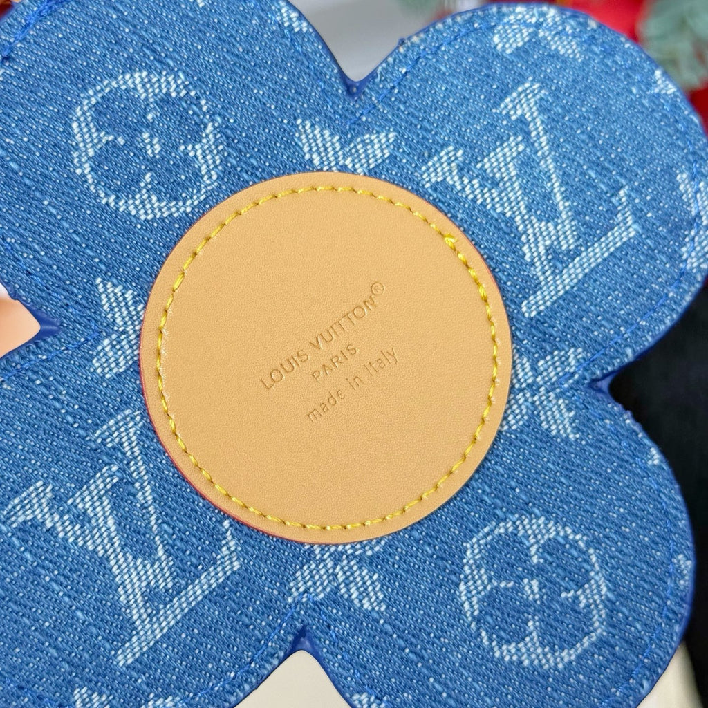 Louis Vuitton blue flower keychain with round beige back tag and logo text