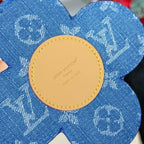 Louis Vuitton blue flower keychain with round beige back tag and logo text