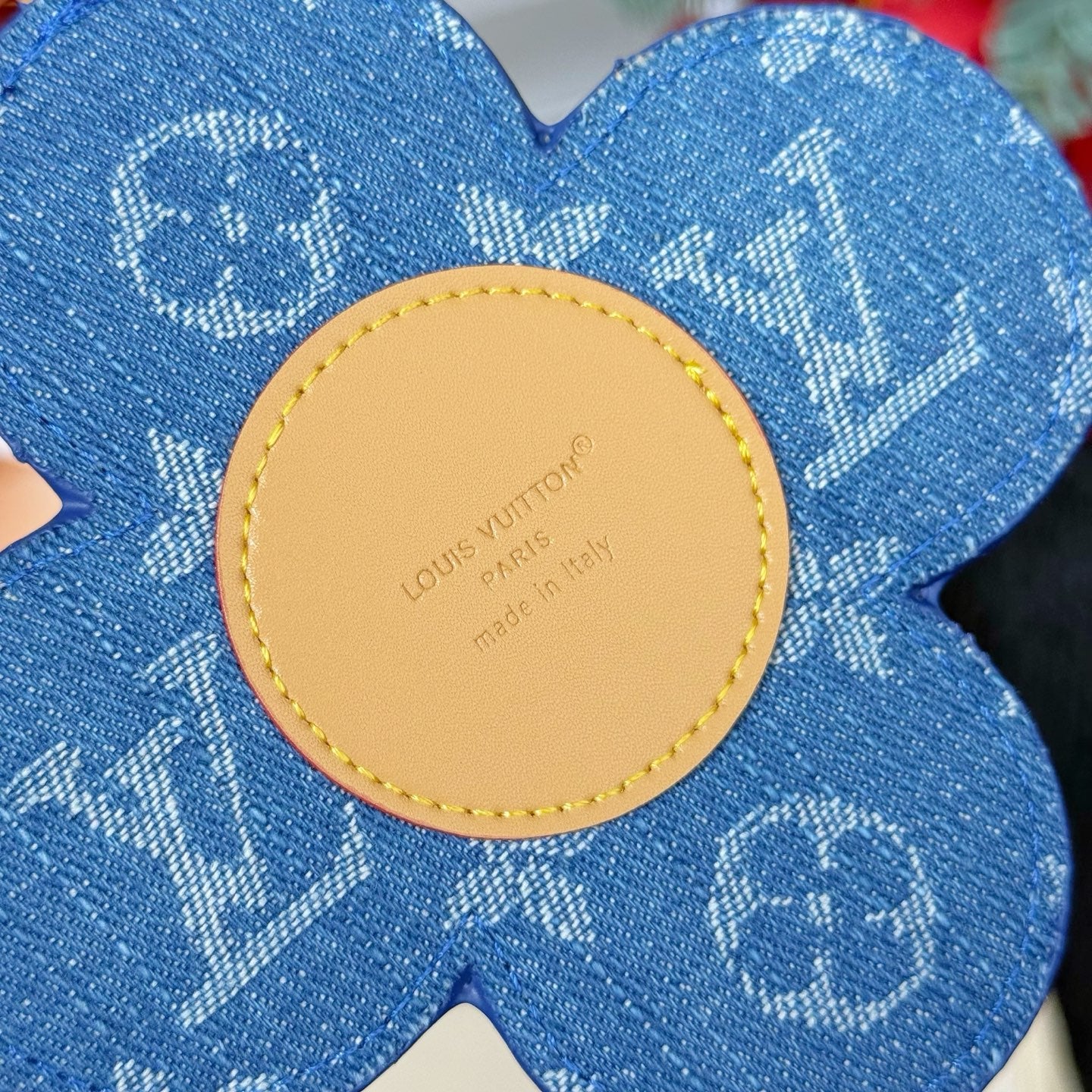 Louis Vuitton blue flower keychain with round beige back tag and logo text
