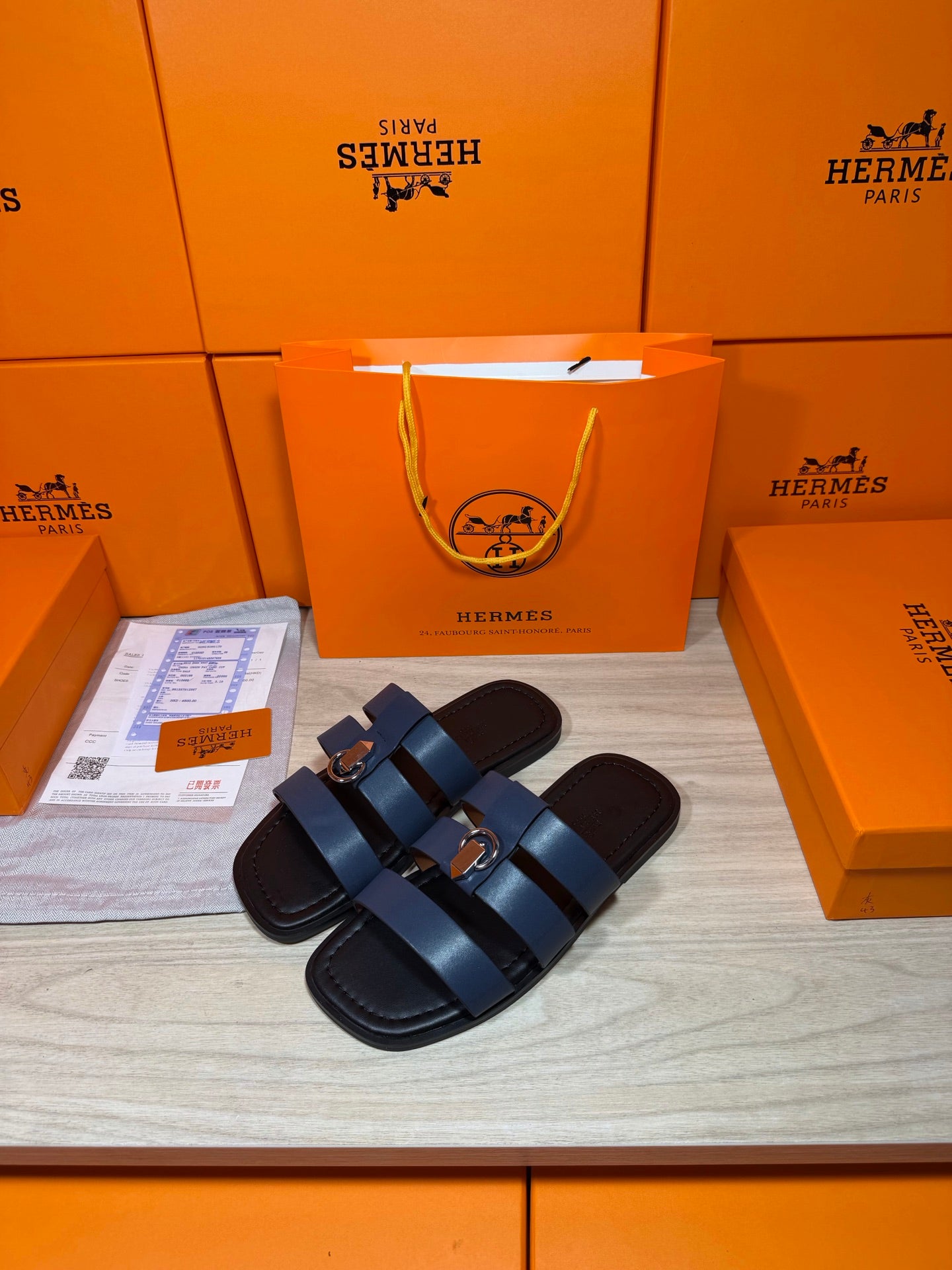 Dark blue leather slide sandals with two strap rows and round metal buckles