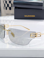 Balenciaga glasses with clear lenses and gold-tone frame, side view