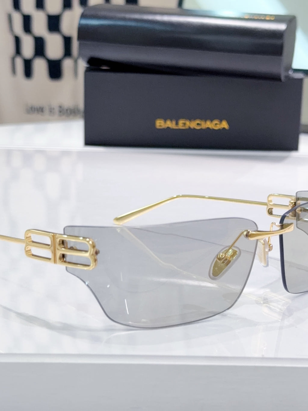 Balenciaga glasses with clear lenses and gold-tone frame, front view