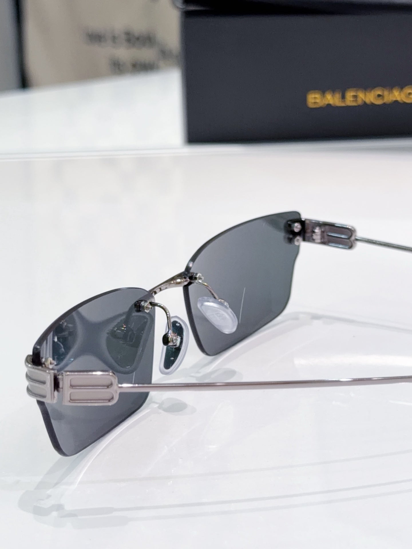 Gold-tone aviator-style sunglasses with dark lenses and metal side hinge