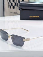 Gold-tone sunglasses with dark lenses and metal temple hinge detail
